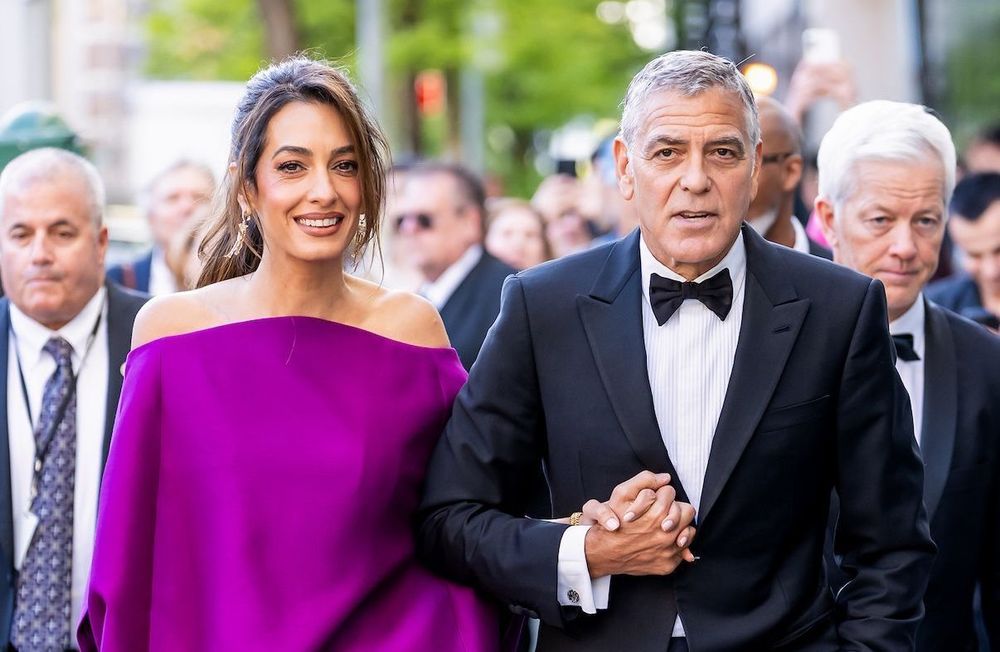 En mini-robe fuchsia aux épaules dénudées, Amal Clooney fait sensation au bras de George Clooney